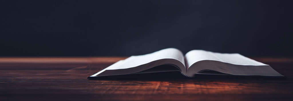 open book on wooden desk background