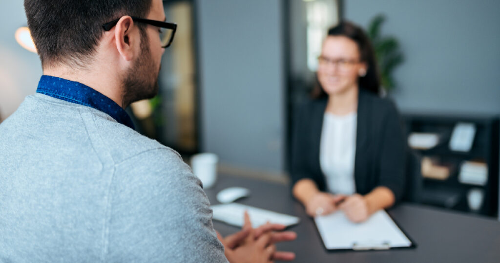 Woman interviewing male tech worker