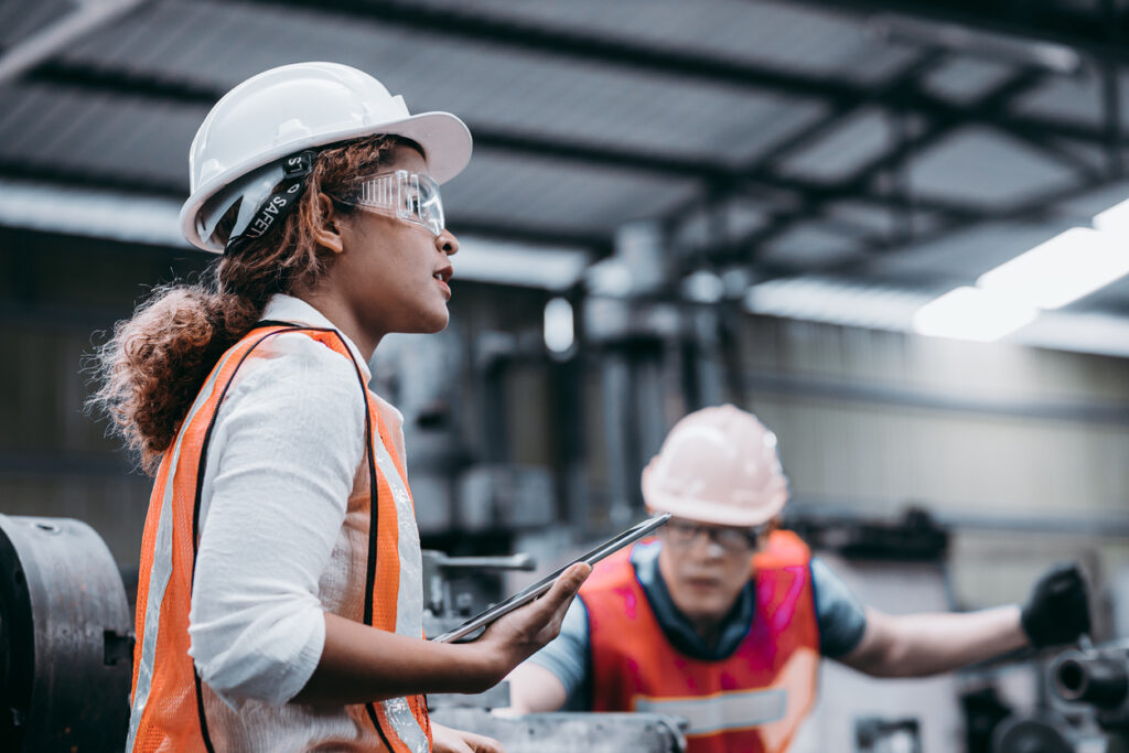 Female industrial engineer wearing a white helmet