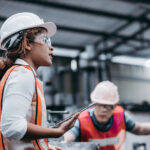 Female industrial engineer wearing a white helmet