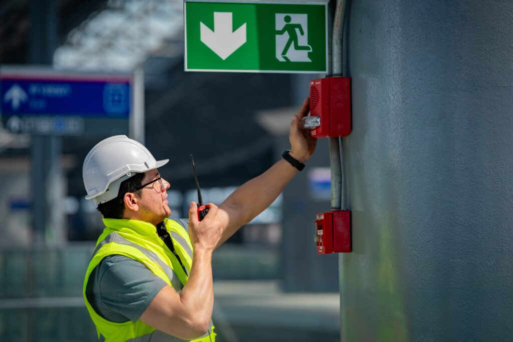 Facility technician inspecting building equipment, illustrating how operational data and maintenance history can support smarter building operations.